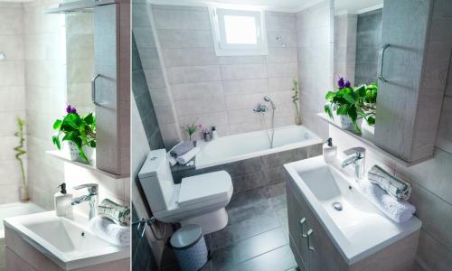 een badkamer met 2 wastafels, een toilet en een bad bij Sea Breeze Experience in Kavala