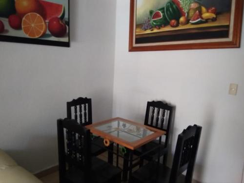 a table and chairs in a room with a painting at Casa con alberca!! Ixtapa Zihuatanejo in Zihuatanejo