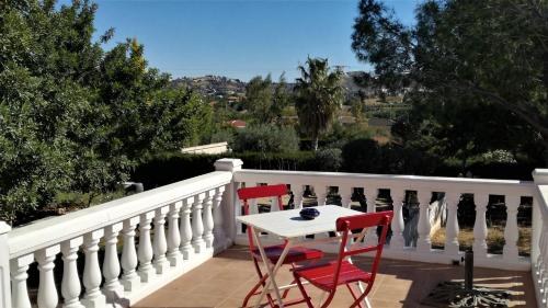 a table and two chairs on a balcony at CASA MARTINEZ Studios & Chambre d'Hôtes à 3 kms de MONTSERRAT VALENCIA in Montroy