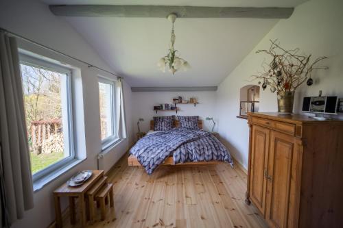 a bedroom with a bed and a window at Goldhammer in Hagebök