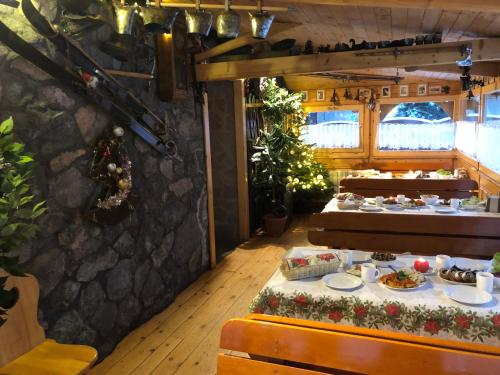 a dining room with a table with food on it at Rusałka in Zakopane