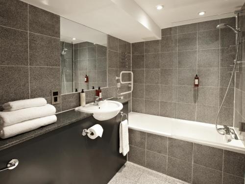 a bathroom with a sink and a bath tub at 196 Bishopsgate in London