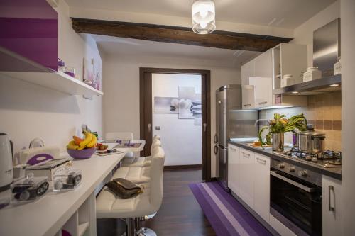 a kitchen with white counters and a refrigerator at Domus Paradiso in Rome