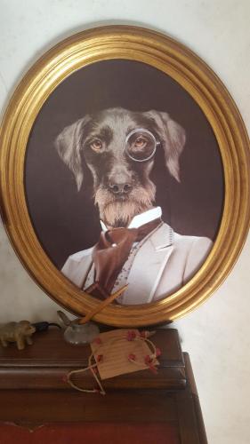 a painting of a dog wearing a suit and goggles at La Belle Vie B&B in Montréal