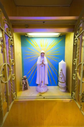 a statue of an angel on a wall in a room at Hotel zum Kirchenwirt Mariazell in Mariazell