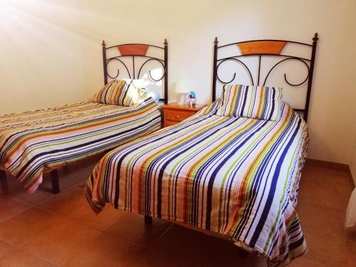 ガルダーにあるCasa El Salitreのベッド2台が隣同士に設置された部屋です。