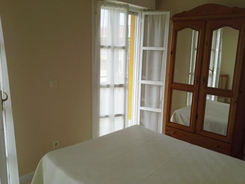 A bed or beds in a room at Apartamentos San Pedro en Llanes