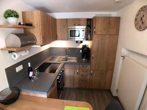 a small kitchen with a sink and a microwave at Gästehaus Amort Ferienwohnung in Ramsau