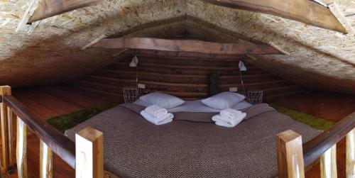 a room with a bed in an attic at Шаленарозі in Migovo