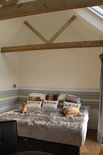 a bedroom with a bed with pillows on it at The Pump-House in Chichester