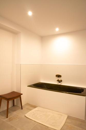 a bathroom with a black sink and a table at Apartment FreiRaum in Innsbruck