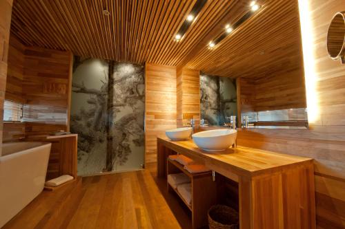 a bathroom with two sinks and a bath tub at Tierra Patagonia Hotel & Spa in Torres del Paine