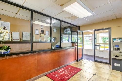 a lobby with a reception desk in a building at Red Carpet Inn - Stamford in Stamford