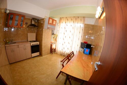 a kitchen with a table and a dining room at David Aprilia in Mamaia Sat/Năvodari