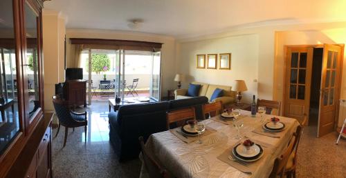 a living room with a table and a couch at Beach House, Labruge, Porto in Labruge