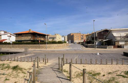 an empty parking lot with buildings and a street at Beach House, Labruge, Porto in Labruge