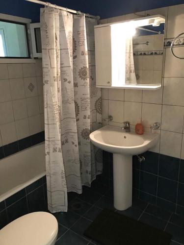 a bathroom with a sink and a toilet and a mirror at Nonika’s House in Tsoukalades