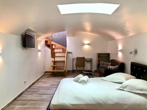 a bedroom with a bed and a living room at LITTLE PLAZA Appart'Hotel in Lille