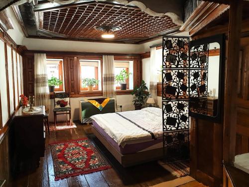 1 dormitorio con 1 cama en una habitación con ventanas en Kulla Dula Guesthouse, en Gjakove