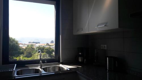 a kitchen with a sink and a window at AL - BOA NOVA in Madalena