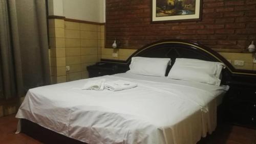Residencial Pinocho في Montero: غرفة نوم عليها سرير وفوط