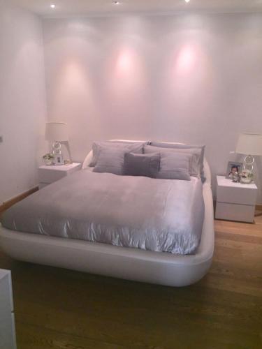 a bedroom with a large bed with two night stands at Franciacorta Suite in Corte Franca