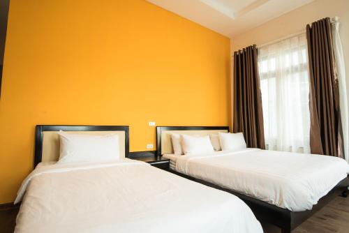 two beds sitting next to each other in a room at Hanoi Buffalo Hostel in Hanoi