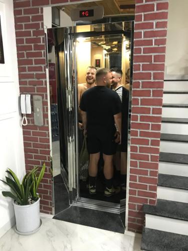 a group of men standing in front of a mirror at Hue Four Seasons Hotel in Hue