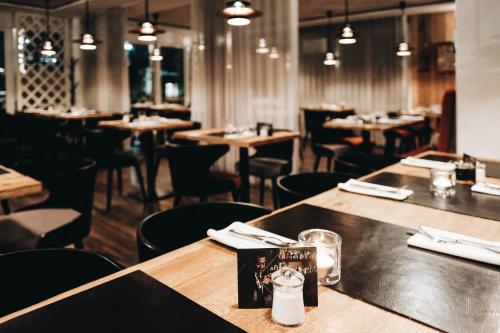 a dining room with wooden tables and chairs at Achtender in Metzingen