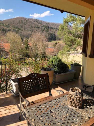 a bench on a porch with a view of a mountain at Buhl de Bonheur in Guebwiller