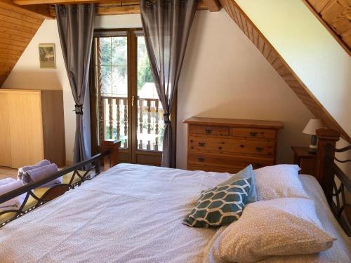 a bedroom with a bed and a window at Buhl de Bonheur in Guebwiller