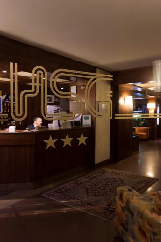 a lobby with a bar with stars on the wall at Hotel San Giorgio in Udine