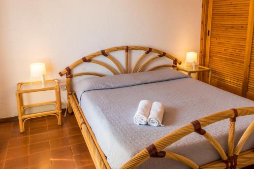 a bedroom with a bed with two slippers on it at Casa_Molara in Porto San Paolo