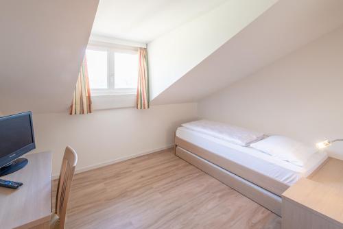 Ένα ή περισσότερα κρεβάτια σε δωμάτιο στο Garni Hotel Ritterhof