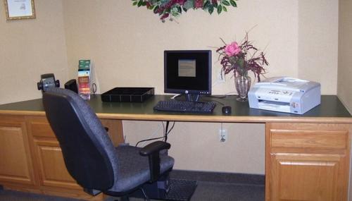 an office desk with a computer and a chair at Country Inn & Suites by Radisson, Sycamore, IL in Sycamore