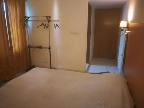 a bedroom with a bed and a room with a closet at Rajanigandha Family Suites in Dhaka