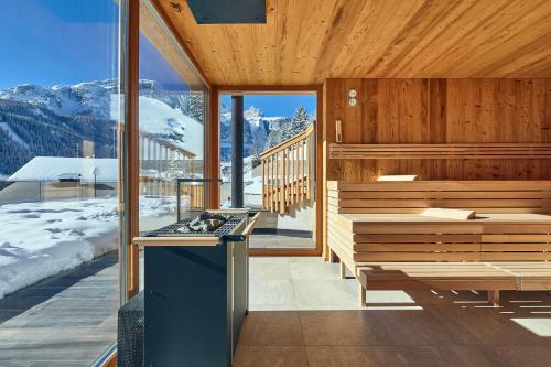 a kitchen with a view of a snowy mountain at Hotel Sassongher in Corvara in Badia
