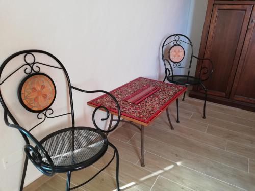 ヴォルテッラにあるCasa Mosaicoの椅子2脚、テーブル1台、テーブル1台、椅子1脚