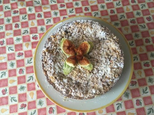 a cake with a flower on a plate on a table at La Biocca in Poggio Murella