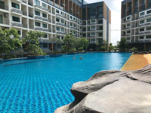 a large swimming pool in a building with people in it at Laguna Beach Resort 2 in Jomtien Beach