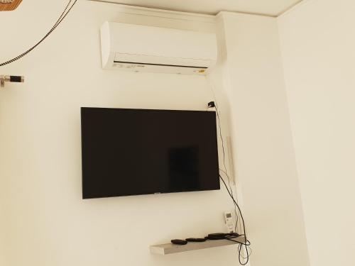 a flat screen tv hanging on a wall at Alimos Studio Apartment in Athens