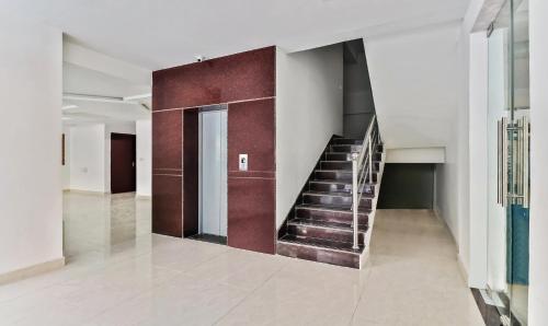 a hallway with a staircase in a building at Treebo Blu Orchid in Bengaluru