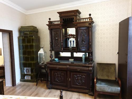 a large wooden cabinet with a mirror in a room at Casa Kogalniceanu in Constanţa