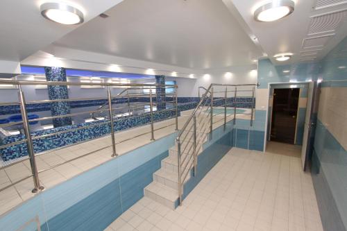 a swimming pool on a cruise ship with a staircase at Fisherman's House in Ustka