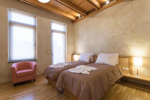 a bedroom with a bed with towels on it at Polixeny's Suites in Chania Town
