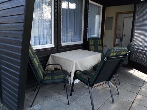 einen Tisch und vier Stühle auf einer Veranda in der Unterkunft Ferienhaus Lilienstein in Bad Schandau