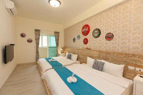 a bedroom with two beds and a brick wall at D3 Classic BNB in Wujie