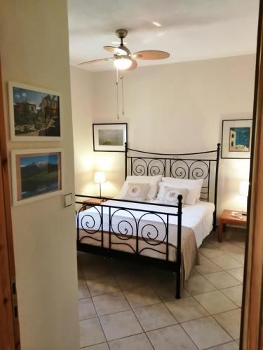 a bedroom with a black bed with white pillows at Family House by the Sea in Nikiti