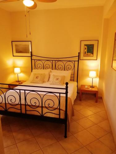 a bedroom with a bed and two lamps on tables at Family House by the Sea in Nikiti
