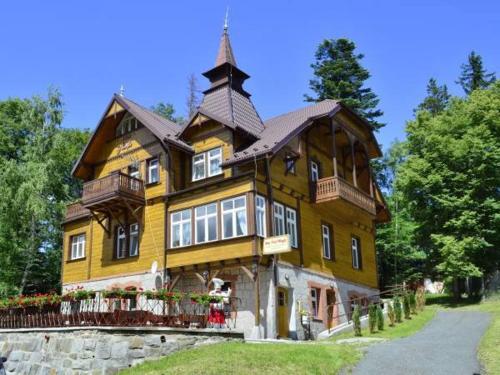 a large wooden house with a tower on top at Willa Nimfa -Również na wyłączność dla Grup nocleg z wyżywieniem in Szklarska Poręba